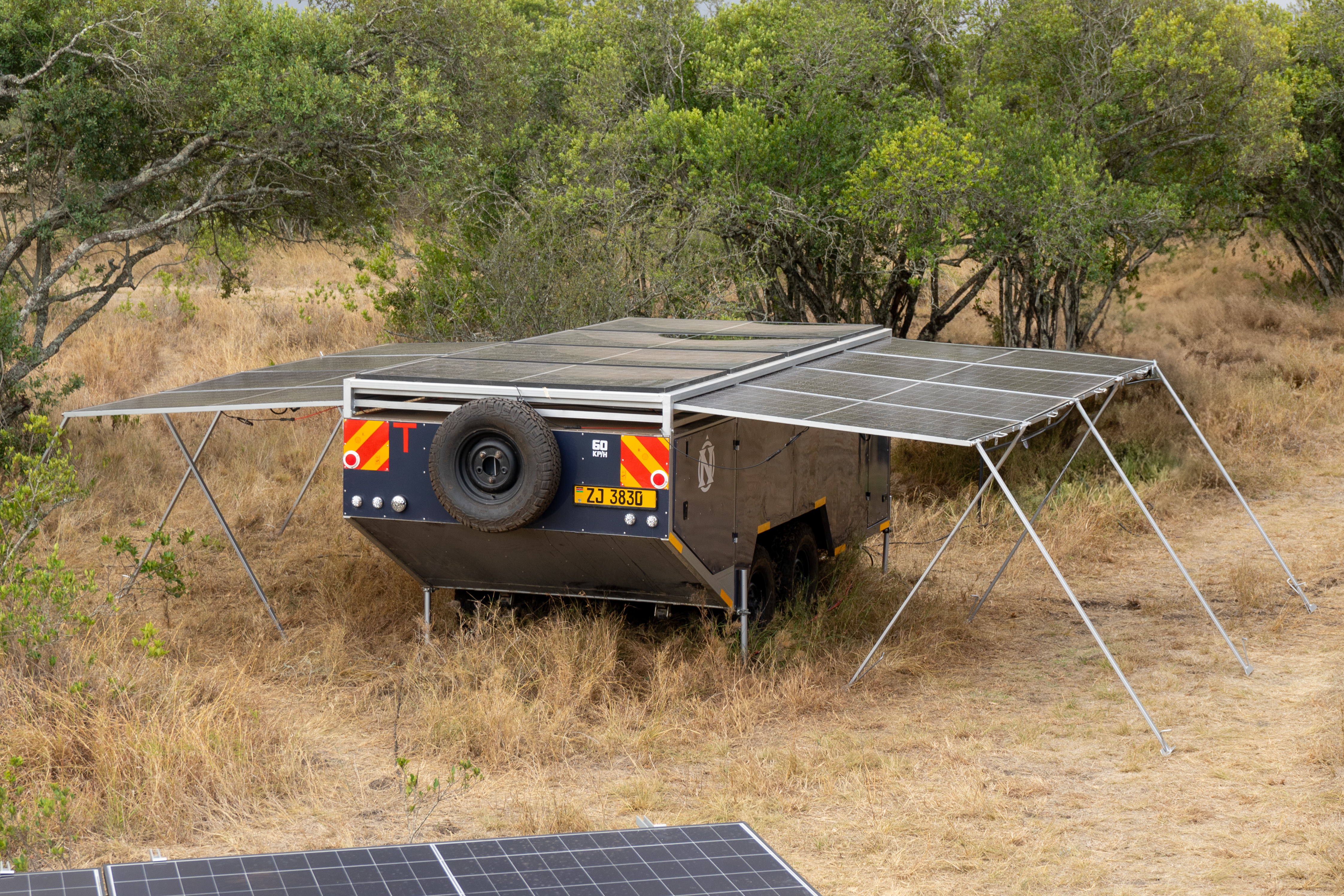Solar trailer from above, panels extended in the field
